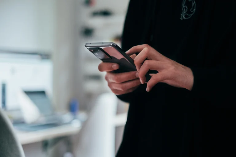 Person using smart phone in office