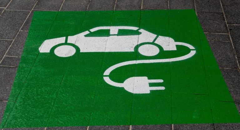 Electric car sign sprayed on floor in green and white